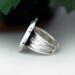 left side view, cushion black onyx gemstone bezel set bead wire and stamped cutout wire accent on tapered wide band